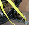 7 Inch Steel Motorcycle Wheel Chock For E Track And X Track System Powder Coated Black Fits Front Tires Up To 7 Inches Wide And 12 Inch Depth Ideal For Trailer Use 2 Pack By Mytee Products installed in trailer with yellow straps securing bike wheel.