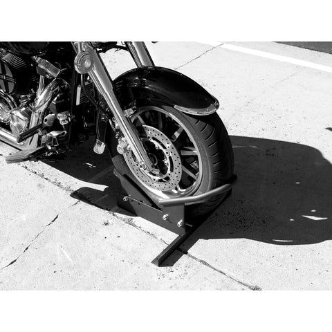 Deluxe Motorcycle Wheel Chock And Tie-Down Kit Extreme Max 5600.3204 securing a motorcycle on pavement