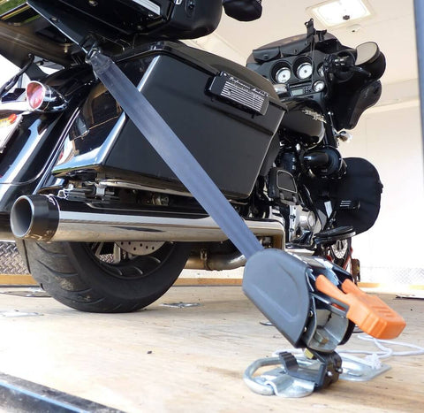 Deluxe Motorcycle Wheel Chock Kit With Quick Release Ratchet Straps And D Ring System Orange And Black For Rock Solid Front And Rear Tie Downs From Lock N Load securing a motorcycle on a trailer.
