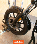 Heavy Duty Motorcycle Wheel Chock For Trailers That Connects To X Track And E Track Systems And Stabilizes Front Or Rear Wheel, Fits Up To 7 Inch Wide Tires, Ideal For Secure Hauling On The Move CargoSmart shown securing a motorcycle wheel in a trailer.