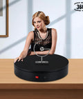 Woman demonstrating 32cm Motorized Rotating Platform With 350lbs Capacity For Photography And Display on a wooden table