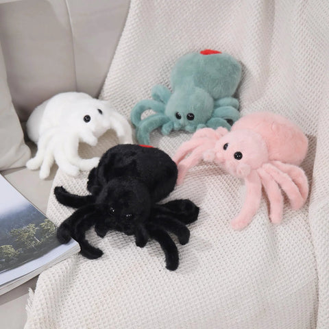 Ultra Soft Black Spider Plush Toy For Kids And Adults shown with colorful plush buddies on a blanket, cozy decor and cuddle companions.