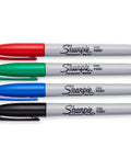Fine point permanent markers deliver bold, precise lines with quick-drying, odorless ink. Red, green, blue, black markers lying side by side.