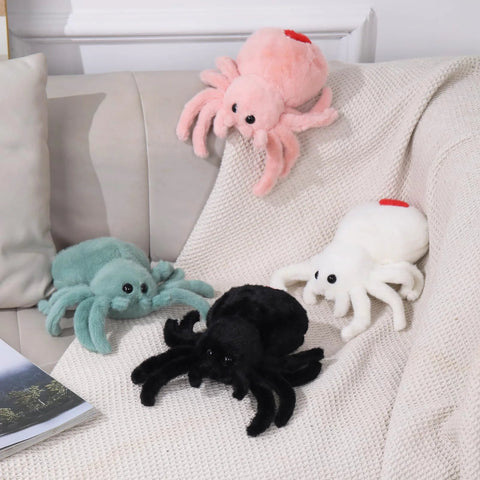 Super Soft Pink Spider Plush Toy For Kids And Adults on a couch with other colored plush spiders
