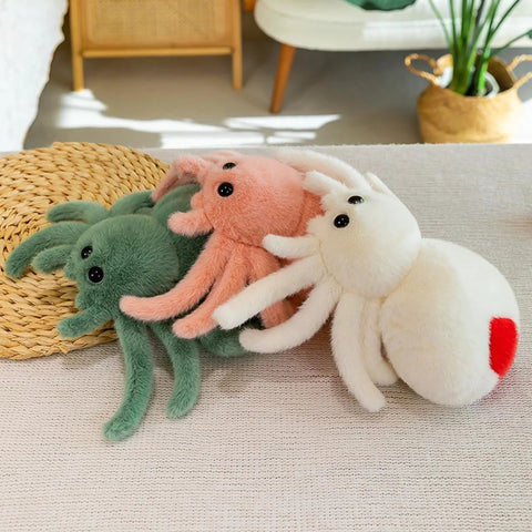 White Spider Plush Stuffed Animal Toy For Kids With Ultra Soft 9.8 Inch Jumping Spider Plushie in white, pink, and green colors on couch