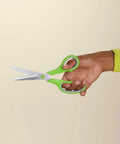 Hand holding Stainless Steel Scissors Multipurpose Office And Craft Shears With PVD Coated Blades For Superior Cutting Power