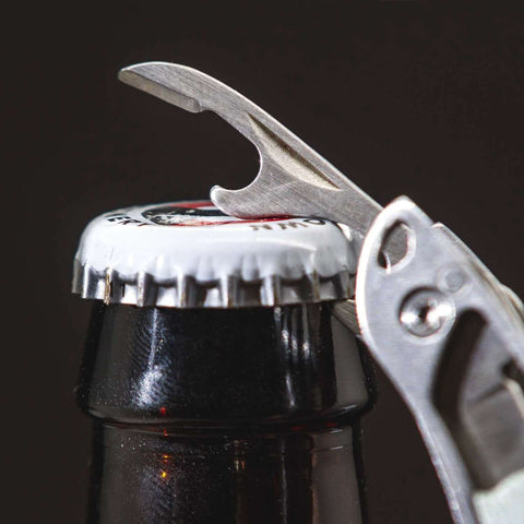 Framework Mini 11 In 1 Multitool Open Frame with bottle opener in use on a bottle cap, showcasing multifunctional capabilities.