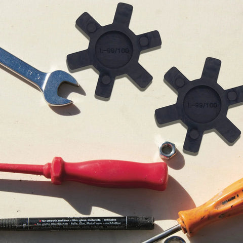 Flexible L100 NBR Rubber Spider Insert for Lovejoy and Martin L Jaw Couplings with tools and hardware on a surface