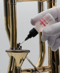 Applying Key And Rotor Oil With Precision Needle Tip Applicator For Brass And Woodwind Instruments on brass instrument valve