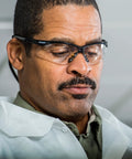 Man wearing Nemesis Safety Glasses With Black Frame Clear Lenses Anti Fog 12 Pack in a work environment