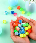 Hands holding assorted neon Small Bouncy Balls in Bulk Rubber High Bouncing Balls for Baby Toddler Birthday Party Favors Gift Game Prizes