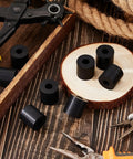 Eight Pack Rubber Spacers 1 Inch OD By Three Eighths Inch ID By 1 Inch Thick Neoprene Washers among tools on wood surface