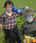Children wearing Protective Goggles Two Pack For Nerf Gun Battles Lightweight Safety Glasses in blue and red outdoors
