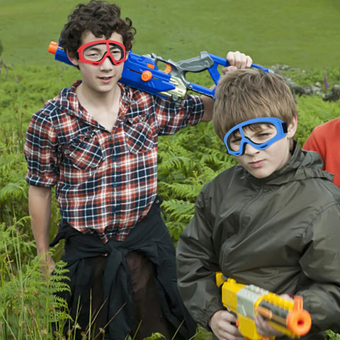Children wearing Protective Goggles Two Pack For Nerf Gun Battles Lightweight Safety Glasses in blue and red outdoors