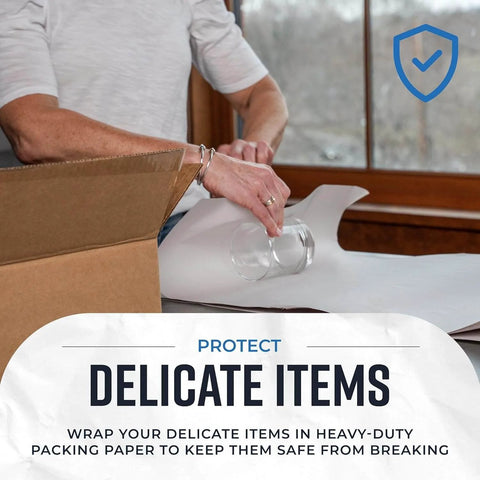 Person wrapping glass with Newsprint Packing Paper Sheets For Moving 10 Lb 320 Sheets 27 By 17 Made In USA For Wrapping Dishes And Fragile Items