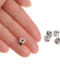 Close-up of fingers holding a 10 Pack Set Screw Shaft Collar with Two Point Zero Five Millimeter Bore, nickel-plated carbon steel.