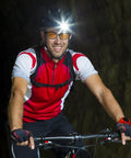 Cyclist wearing Night Vision Driving Glasses With Anti Glare Yellow Polarized Lenses and a headlamp in a tunnel.