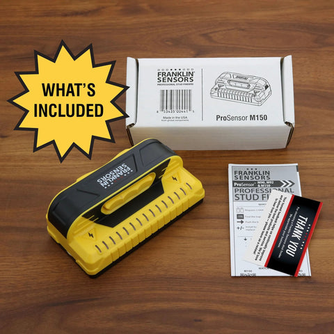 Nine-sensor stud finder and wall scanner with live wire detection, shown with packaging and instructions on a wooden surface.