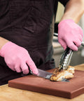 Person wearing Nitrile Exam Gloves 4 Mil Medium Cherry Blossom Powder Free Latex Free Food Safe slicing chicken