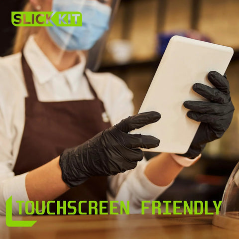 Person wearing Nitrile Disposable Gloves 4 Mil Latex Free Powder Free Black XL 100 Count using a tablet in a cafe setting.