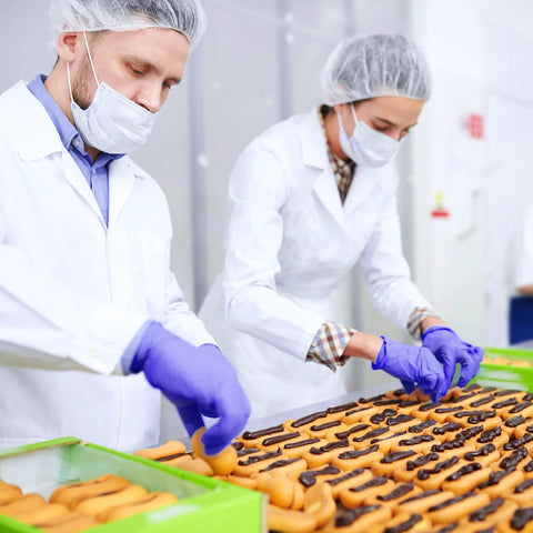 Workers handling food wearing Nitrile Gloves Powder Free Latex Free 4 Mil Ultra Strong Large 100 Count in a clean environment.