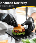 Chef wearing black nitrile exam gloves latex free powder free disposable for medical and food prep, handling a burger.