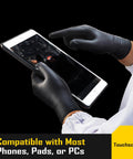 Person using touchscreen device wearing 8 Mil Disposable Nitrile Gloves With Diamond Textured Grip 100 Count