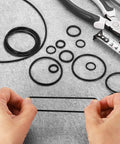 50 Pcs Nitrile Rubber O Rings NBR 1 Inch Internal Diameter 1-1/8 Inch Outer Diameter 1/16 Inch Width 70 Durometer Black Sealing Gaskets displayed on gray surface with tools