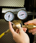 Hands adjusting Nitrogen Regulator With Six Foot Seven Inch Hose For TIG MIG Welding CGA580 Inlet Connection, gauges visible.