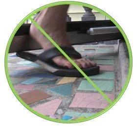 Foot using the Heavy Duty Door Closer System (White) in hands-free mode with hold-open feature, close-up view.