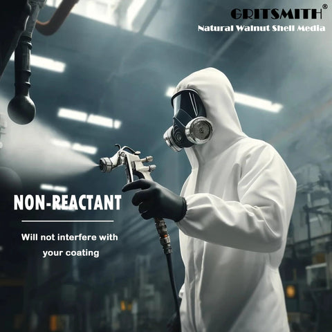 Person in protective suit using blasting equipment with Fine 40 60 Grit Walnut Shell Media for gentle blasting shown in an industrial setting.