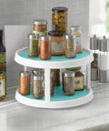 Non-Skid 2-Tier Turntable 12-Inch Lazy Susan Organizer with spices on marble countertop.