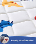 Close-up of non-slip microfiber fabric with colorful dinosaur print on a toddler bed bumper from 2 Pack Premium Foam Toddler Bed Bumpers With Non Slip Rails For Twin Queen And King Beds Cozy Odor Free Comfort Machine Washable Covers Easy Care 52 By 7 By 5 Inches Safe Sleep Aid For Peaceful Nights