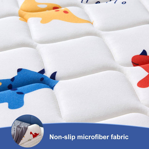 Close-up of non-slip microfiber fabric with colorful dinosaur print on a toddler bed bumper from 2 Pack Premium Foam Toddler Bed Bumpers With Non Slip Rails For Twin Queen And King Beds Cozy Odor Free Comfort Machine Washable Covers Easy Care 52 By 7 By 5 Inches Safe Sleep Aid For Peaceful Nights