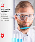 Person wearing Non-Vented Safety Lab Goggles With Anti-Fog Coating ANSI Z87.1 UV Protection OTG over prescription glasses in lab