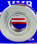 Close-up of NUTR3072 Flat Yoke Roller Bearing 30x72x28mm, sealed both sides, against a colorful background.