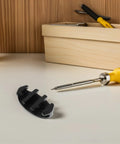 Boat rope cleat, black nylon, deck-mount mooring hardware; close-up view with screwdriver