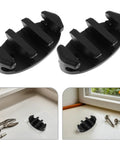 Front view of two black nylon marine rope cleats with screws for deck mounting