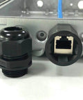Black connector and port on a metal panel, part of Waterproof Nylon Cable Gland Kit With 50 Pieces, 3-16 mm Range, Includes PG7 PG9 PG11 PG13.5 PG16 PG19, IP68 Plastic Glands For Indoor And Outdoor Use