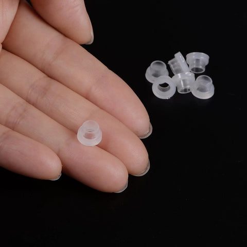 Close-up of a hand holding a 12 Pack Nylon Flanged Sleeve Bearing 4.5mm Bore 5.8mm OD 5mm Length 8mm Flange Diameter 2mm in white.