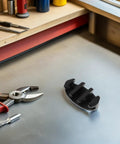 Side view of black nylon deck-mount rope cleat for boat mooring hardware