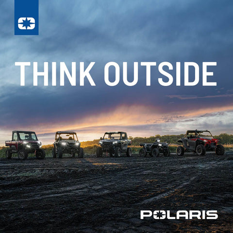 Lineup of Polaris off-road vehicles on a dirt path at sunset, with the text 'Think Outside' above.