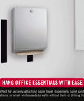 Heavy Duty Tape With Adhesive, Industrial Strength Hook And Loop Fasteners, 15 Feet By 2 Inches, Holds Up To 10 Pounds, Black, Indoor And Outdoor Use, Water Resistant, Cut Strips To Length, shown holding a paper towel dispenser.