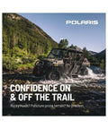 Off-road vehicle driving through water on rocky terrain under clear sky