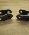 Five Brand New Rexnord REX80-2 Offset Chain Links Lot Of Five Premium Grade Built To Handle Real Tough Jobs In Harsh Industrial Environments Perfect Replacement For Conveyor And Mechanical Drive Chains Easy Install, two chain links on wooden surface.