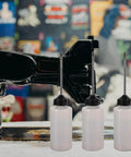Long Mouth Nozzle Oil Bottles For Sewing Machines And Home Tools Three Pack Plastic Oiler Pots next to a sewing machine