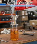 Large capacity tool bottle filling at workshop table with precision needle oiler kit in background, emphasizing accurate lubrication.