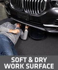 Man working under car on XL Oil Spill Mat For Garage Floors Premium Absorbent Oil Pad Reusable And Washable Durable