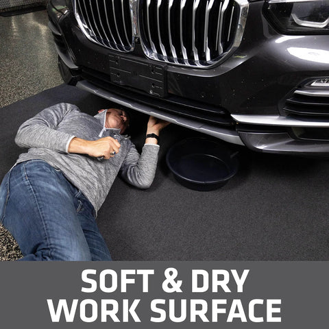 Man working under car on XL Oil Spill Mat For Garage Floors Premium Absorbent Oil Pad Reusable And Washable Durable