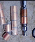 Oilless Bushing Sleeve Bearing 1.25 Inch Bore 1.40 Inch OD 1.17 Inch Length with bronze interlayer and equipment parts visible.